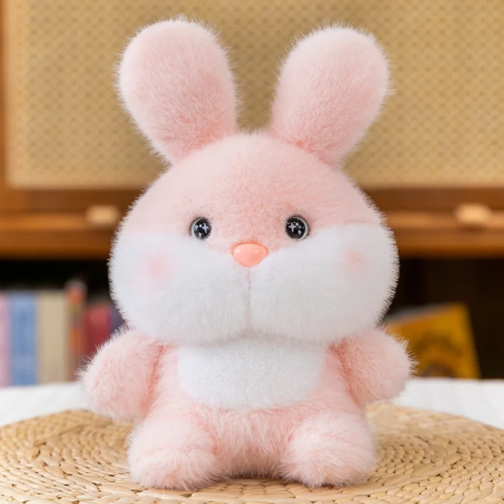 Cute Small Pink plush bunny toy on a woven surface with a blurred background
