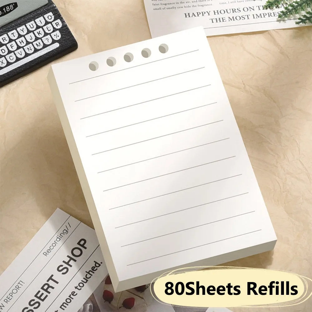 Cute Small notepad 80 lined sheets refill pages on a light wooden surface.