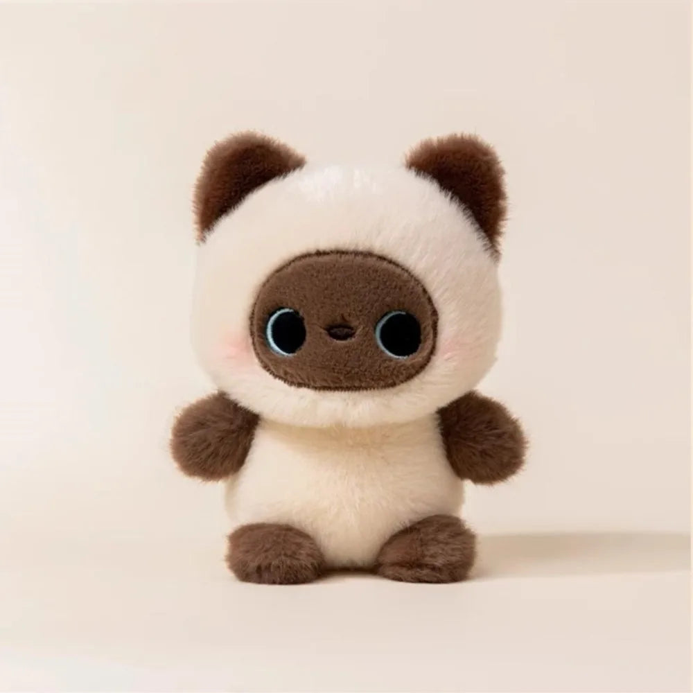 Cute plush Siamese cat toy with big blue eyes, cream body, and dark brown ears and paws, in kawaii style