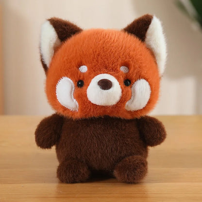 Cute small Plush toy raccoon on a wooden surface with a blurred background